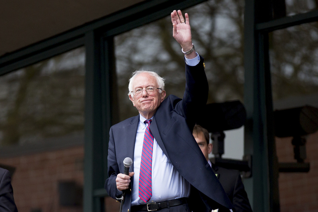 Democratic presidential candidate Senator Bernie Sanders waves to thousands of people waiting outside KeyArena for his rally on March 20, 2016 in Seattle.