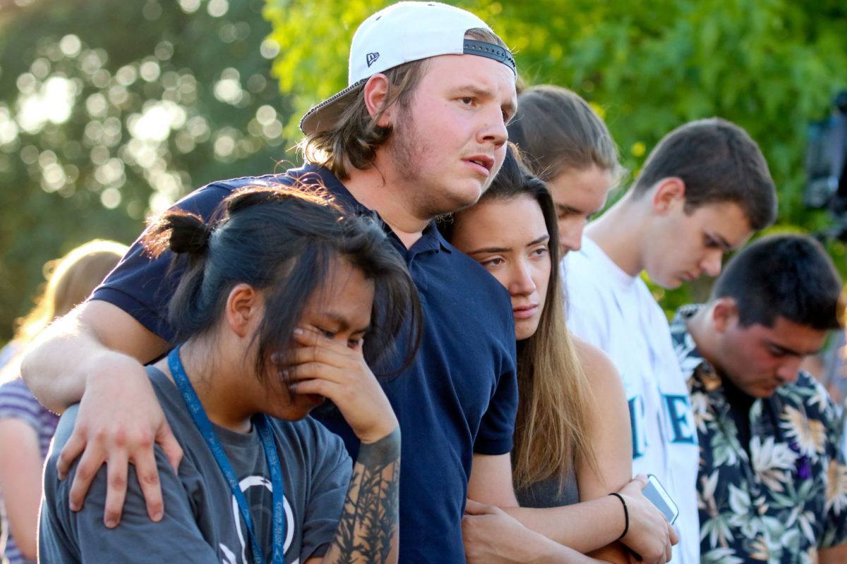 Friends and family gather to remember the victims of the Mukilteo shooting. (Kevin Clark / The Herald)