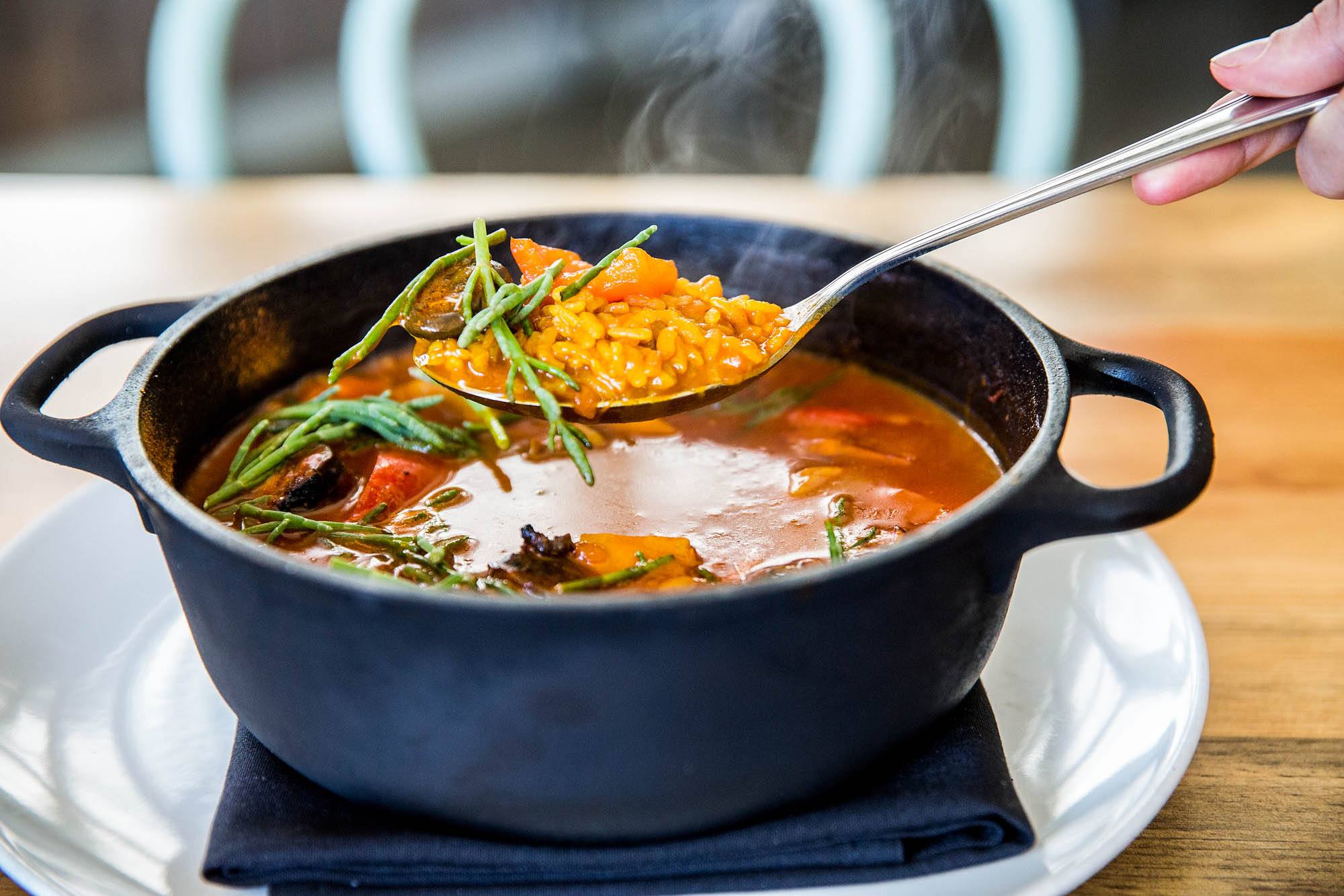 Bomba rice with squid ink and locally foraged mushrooms. Photo by Suzi Pratt