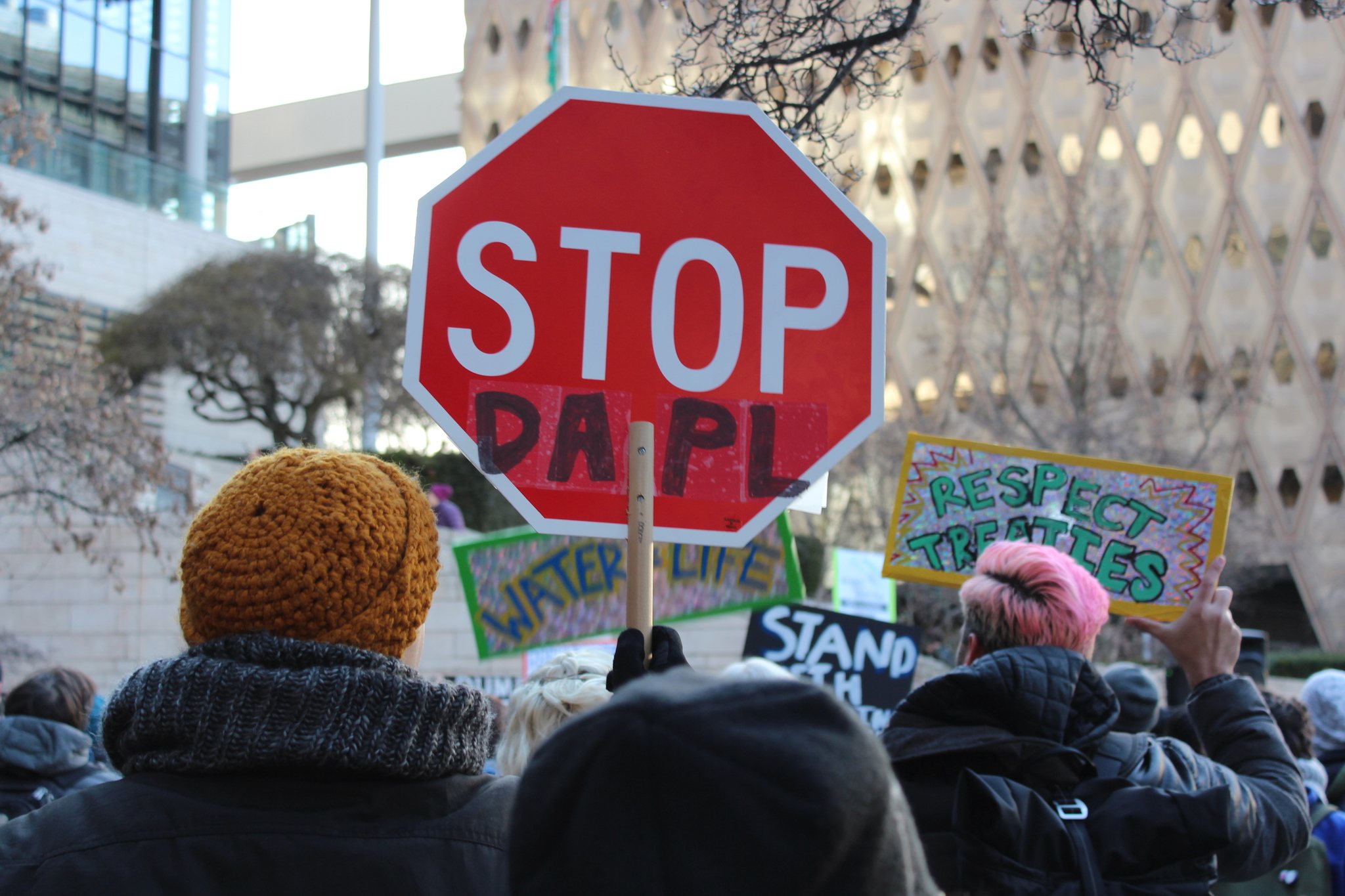 Activists rally outsite City Hall before a finance committee meeting about divesting from Wells Fargo. Photo by Sara Bernard.