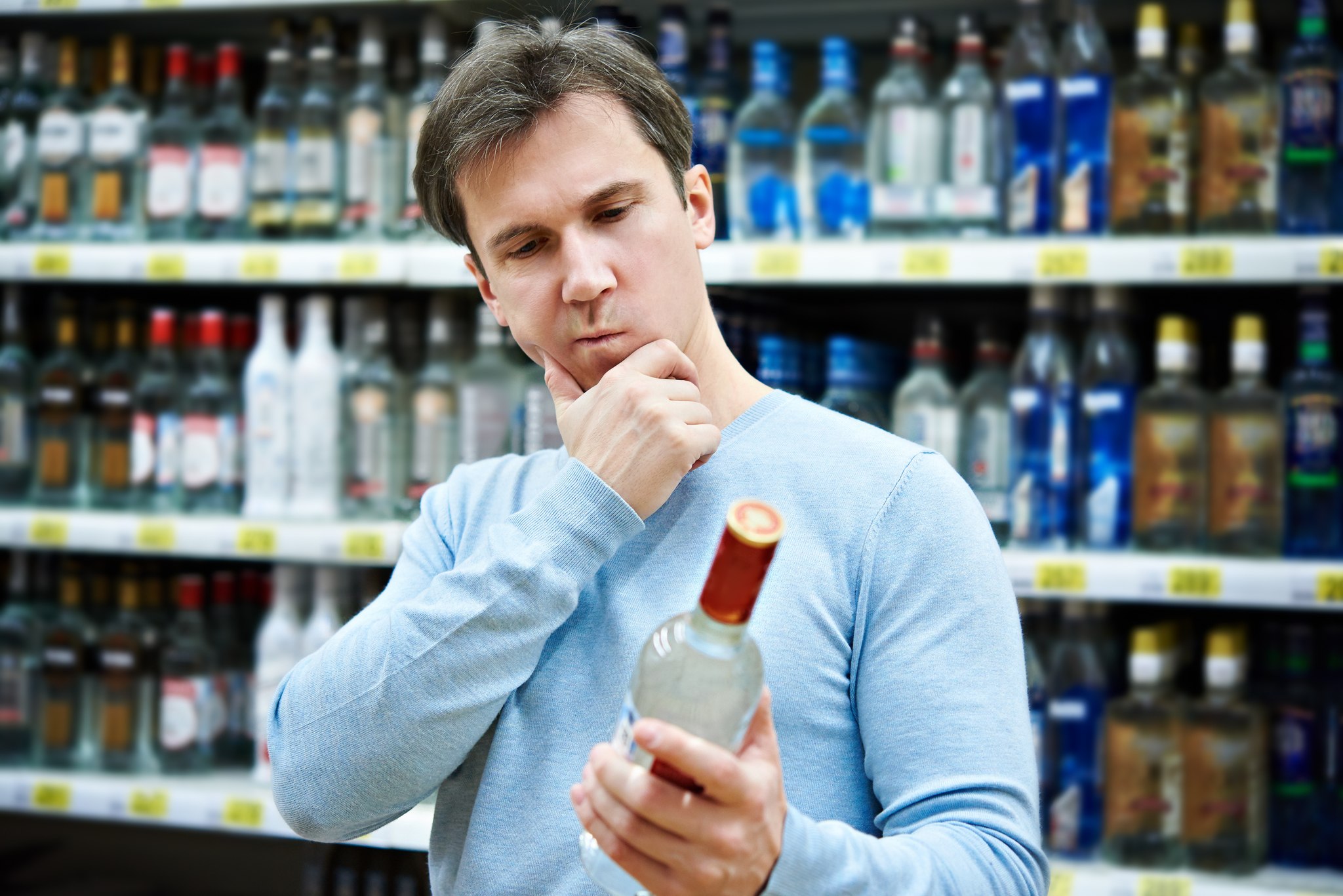 A random gent in a well-pressed shirt thinks about the state of liquor sales in Washington. Thinkstock