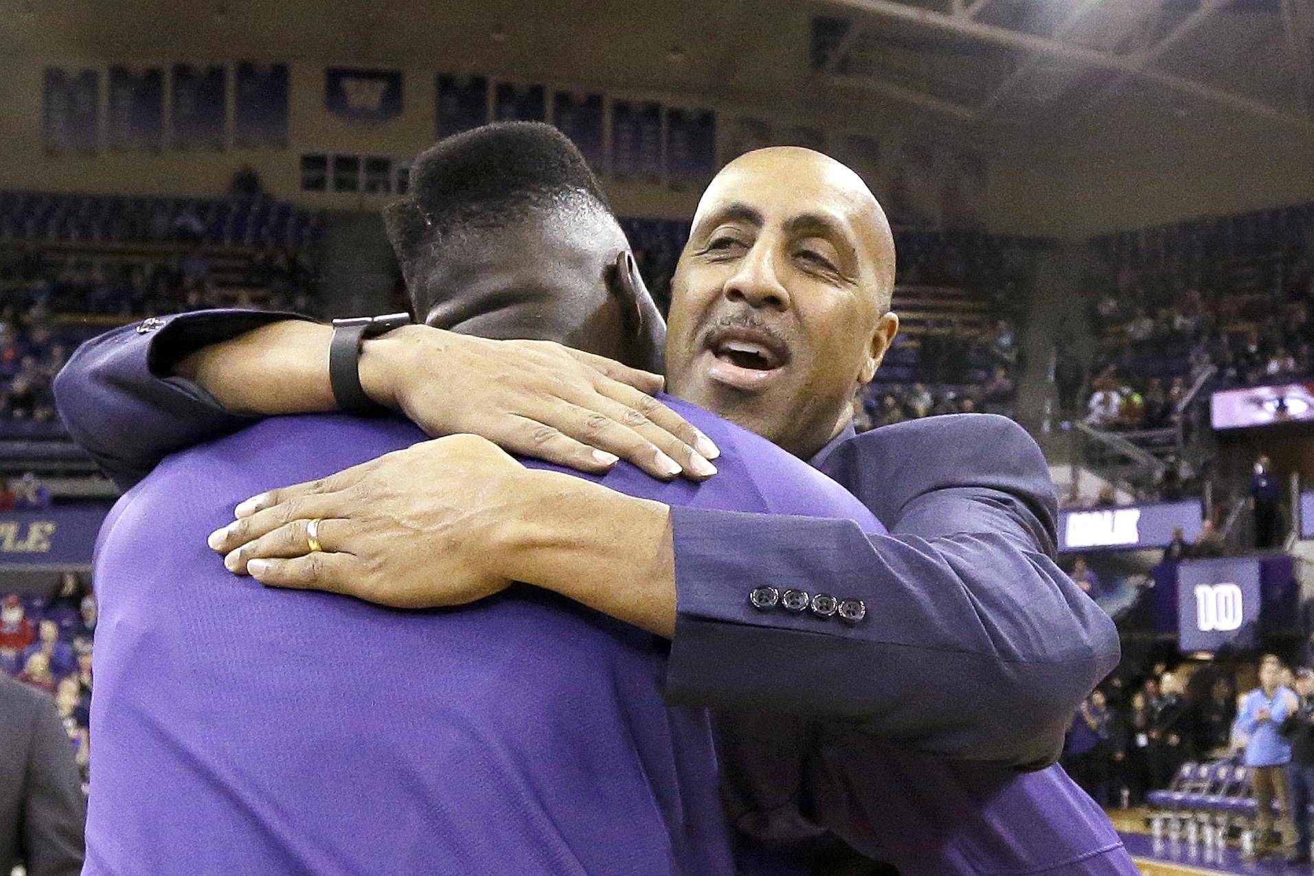 Lorenzo Romar embraces Malik Dime on senior night before one of his final games as coach of the Washington Huskies. AP Photo/Elaine Thompson