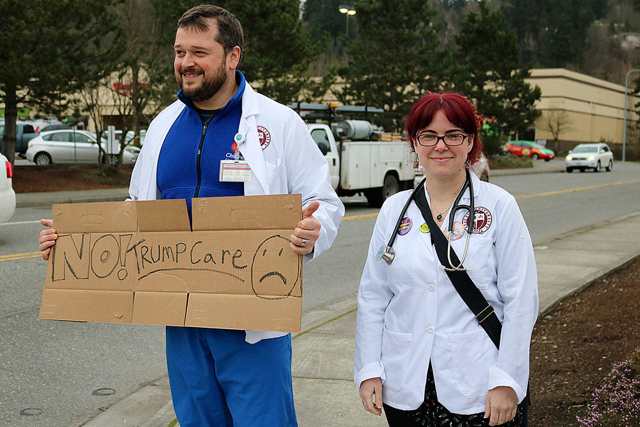 Protesters rally outside Rep. Dave Reichert’s Issaquah office. Nicole Jennings/Bellevue Reporter