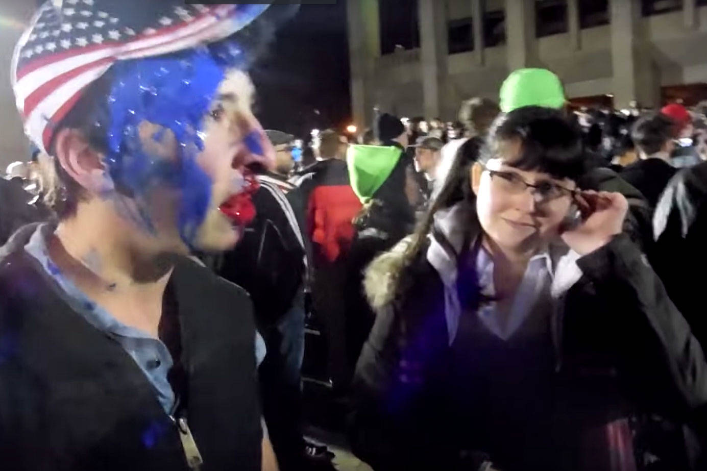 Elizabeth Hokoana, right, seen in an amateur video captured shortly before the shooting. To the left is a Milo Yiannopoulos fan who says he was punched by protesters. Photo via YouTube