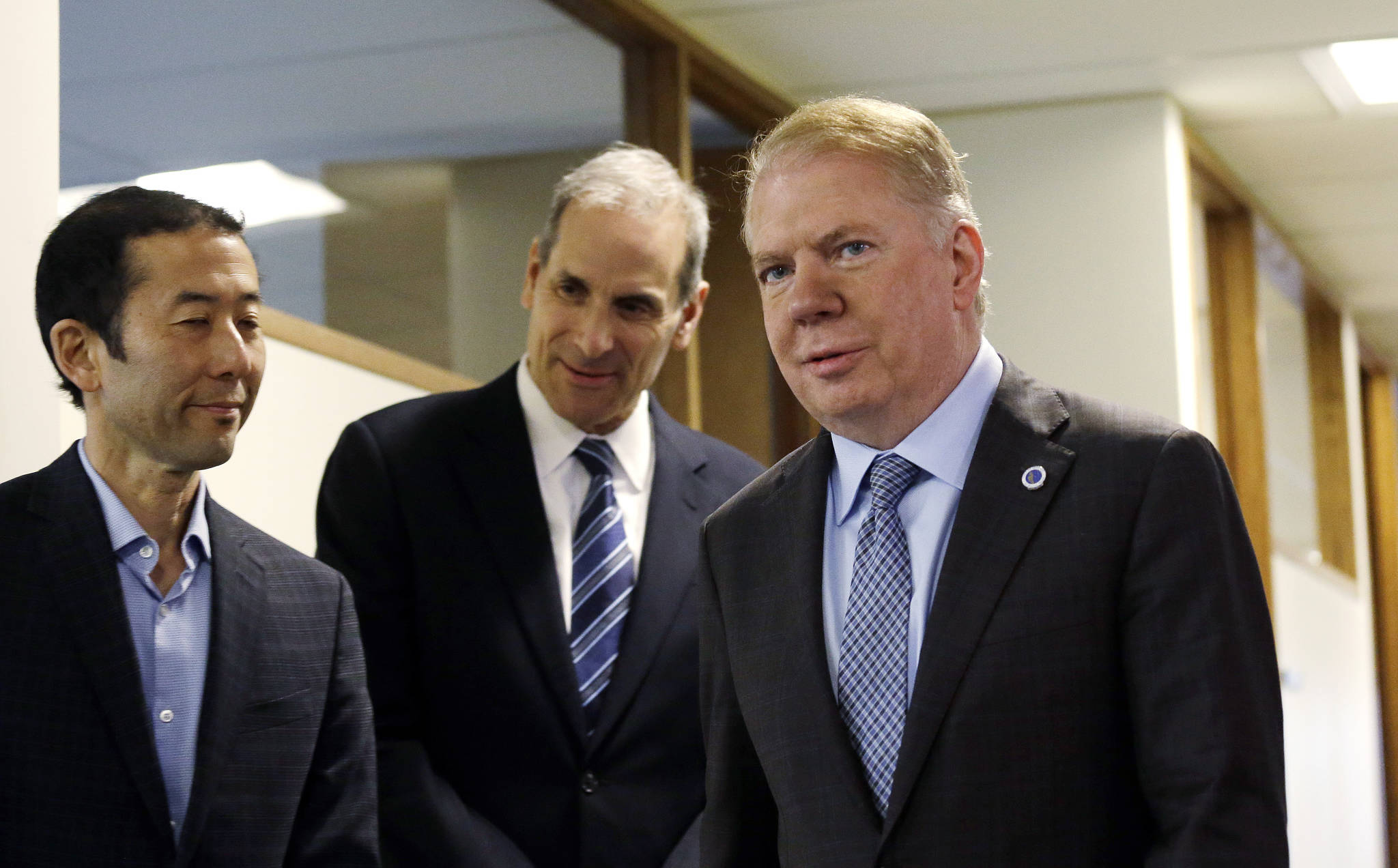 Mayor Murray walks past his husband, Michael Shiosaki, left, and his attorney, Bob Sulkin, before speaking to the media on Friday, April 7, 2017, in Seattle. AP Photo/Elaine Thompson
