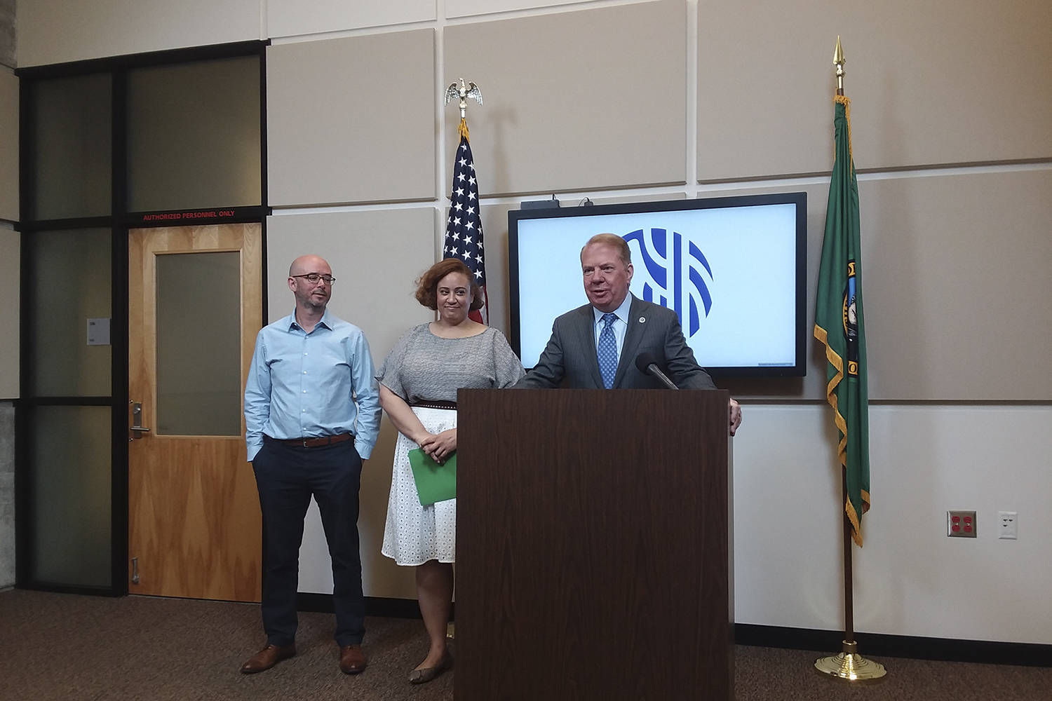 Mayor Ed Murray, flanked by HSD director Catherine Lester and All Home KC director Mark Putnam, announces the city’s new RFP for $30 million in homelessness services. Photo by Casey Jaywork