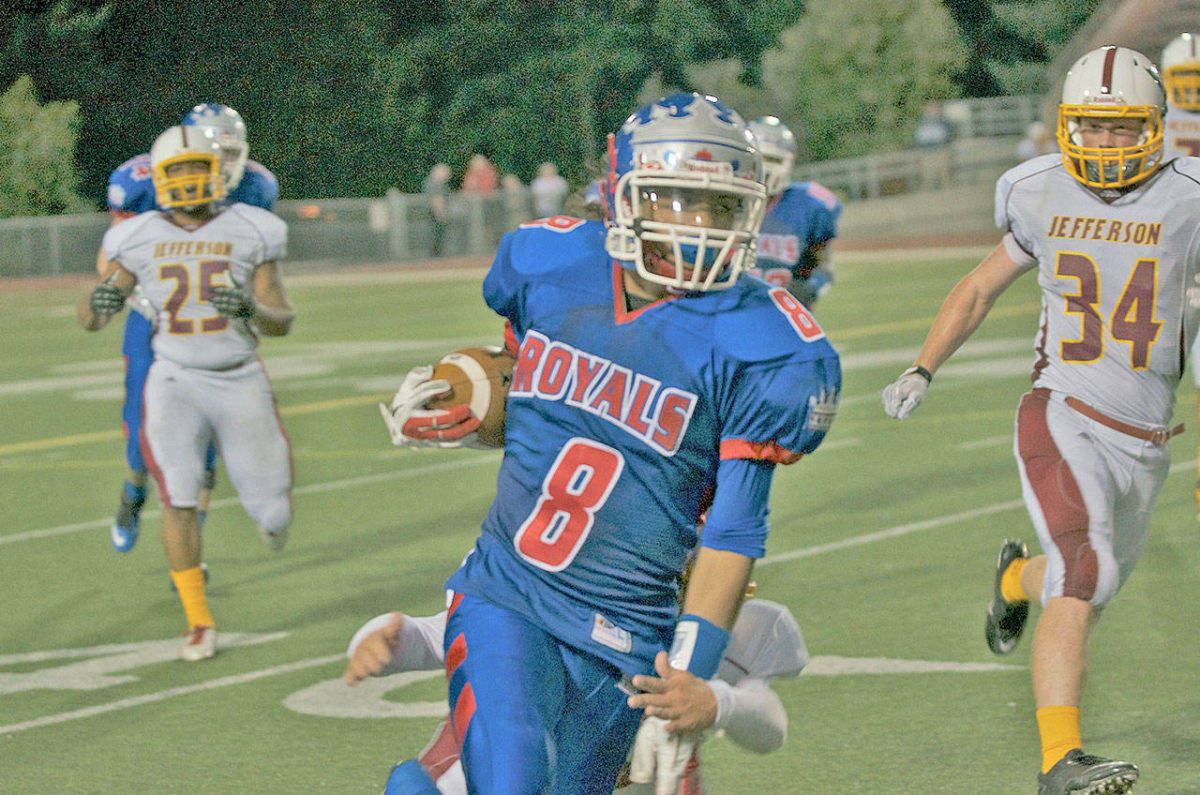Giovonn Joseph-McDade runs with the ball while playing for the Kent-Meridian High School football team in 2013. File Photo/Kent Reporter