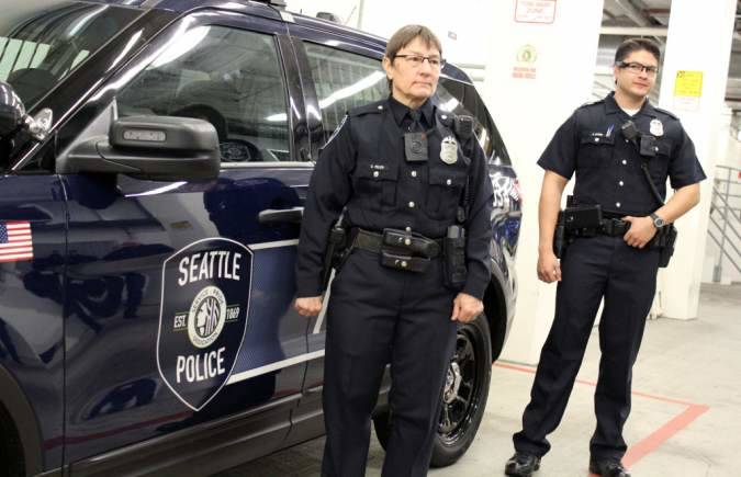 Police pose in uniforms affixed with body cameras. Seattle Weekly archives