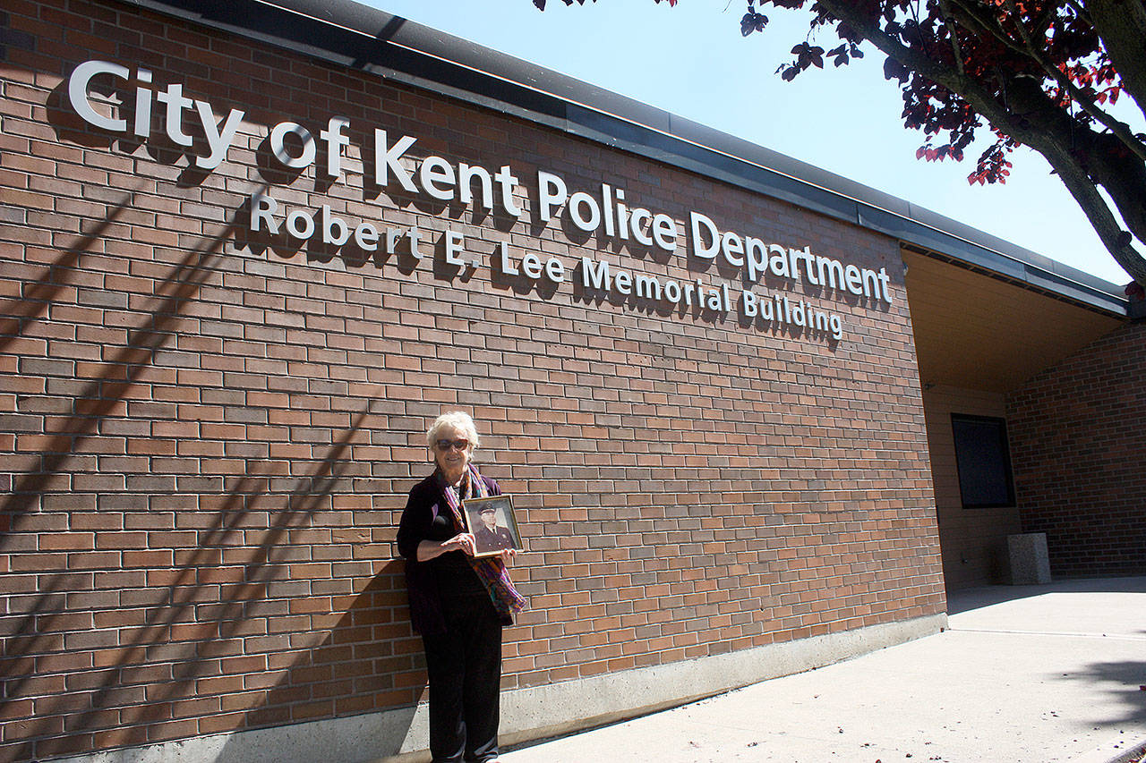 Vicki Schmitz stands next to the city of Kent building named after her father Robert E. Lee, a former Kent Police chief. Photo by Steve Hunter