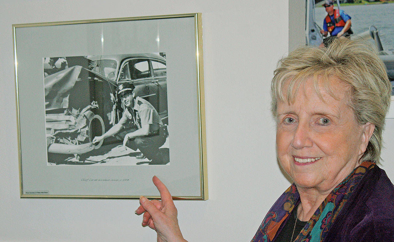 Schmitz points out her father in a photo displayed at the Kent Police station. Photo by Steve Hunter