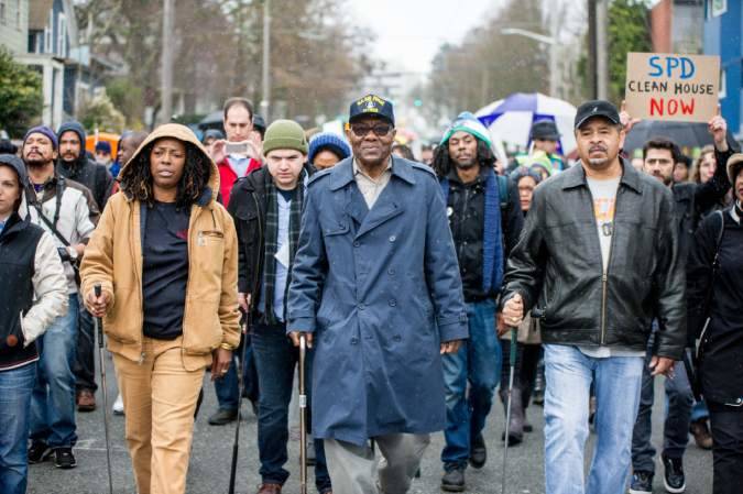 William Wingate, who was arbitrarily arrested by Officer Cythia Whitlatch for using a golf club as a cane, leads a protest march on February 7, 2015. Photo by Kaia D’Albora
