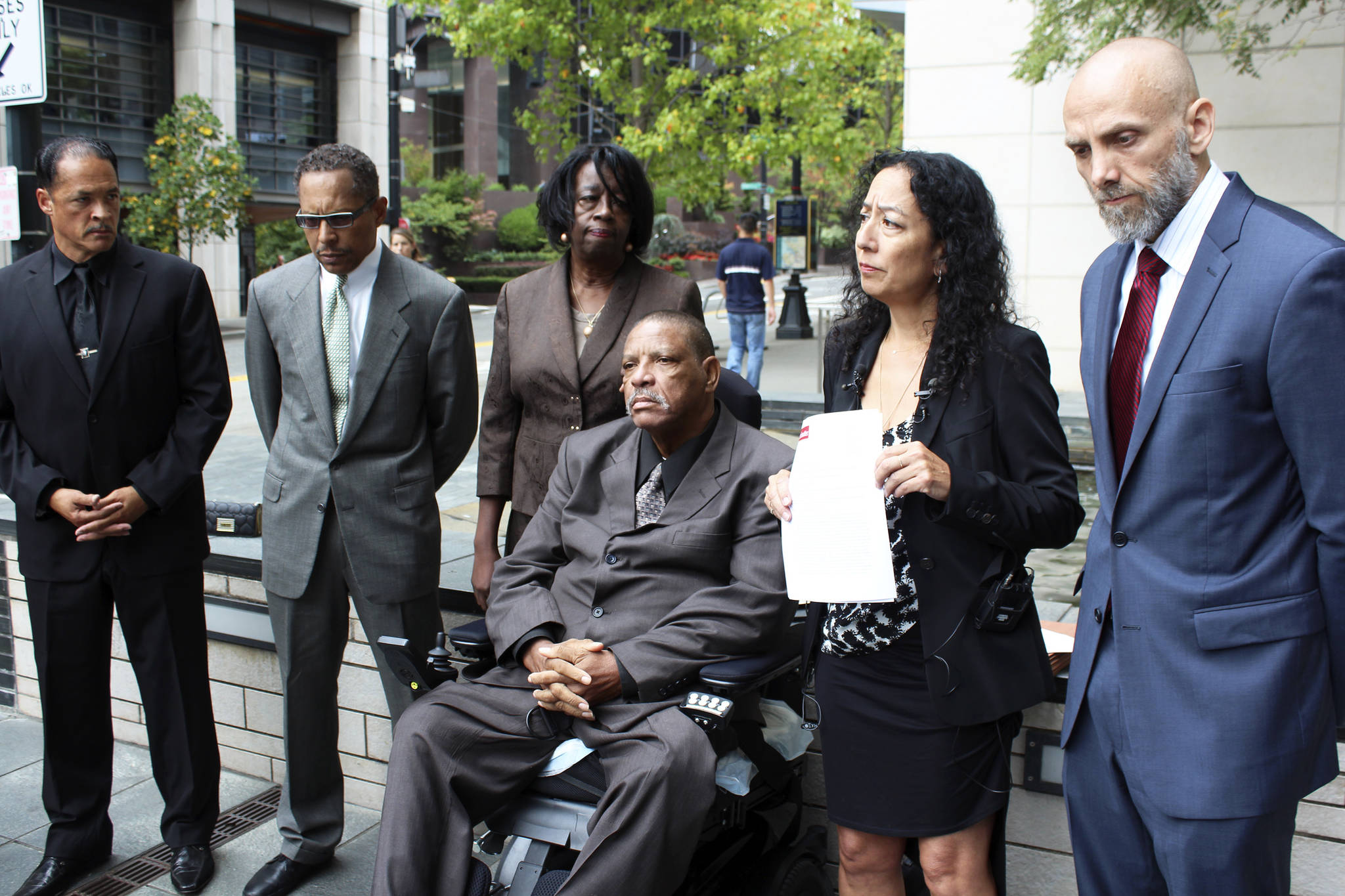 Lawyers representing Charles Lyles (center) hold a press conference outside SPD headquarters. Photo by Sara Bernard