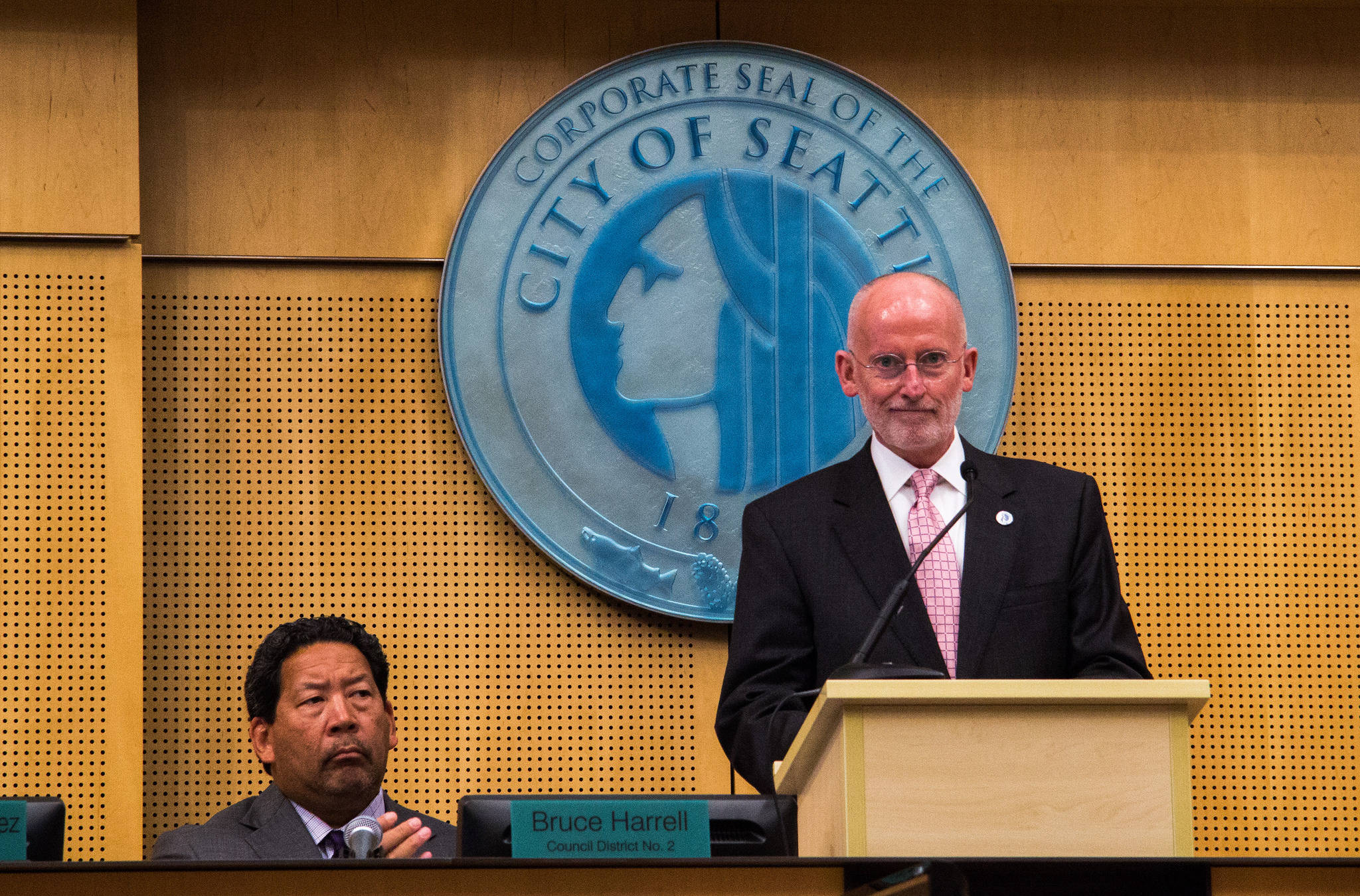 Council President Bruce Harrell (left) listens to interim mayor Tim Burgess present his proposed city budget. Photo by Joseph Peha, courtesy of Seattle City Council