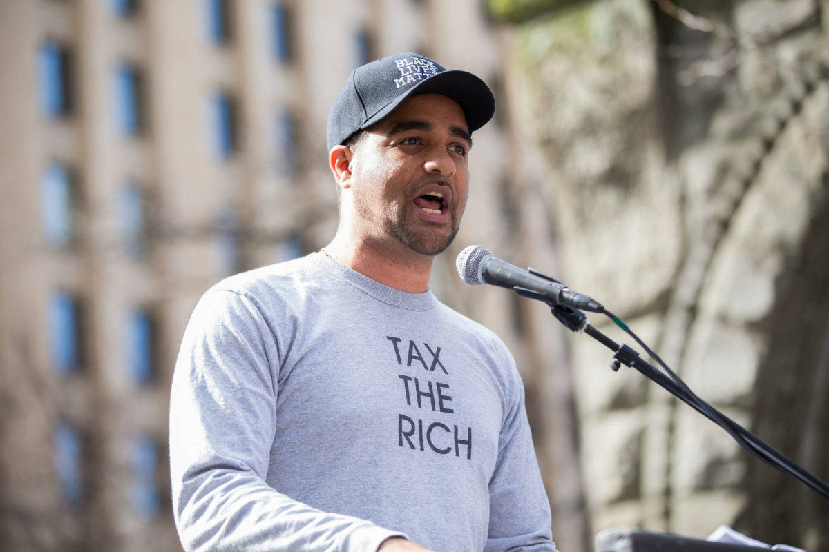 Jesse Hagopian sports a “tax the rich” t-shirt. Seattle is trying to do just that. Photo by Alex Garland.
