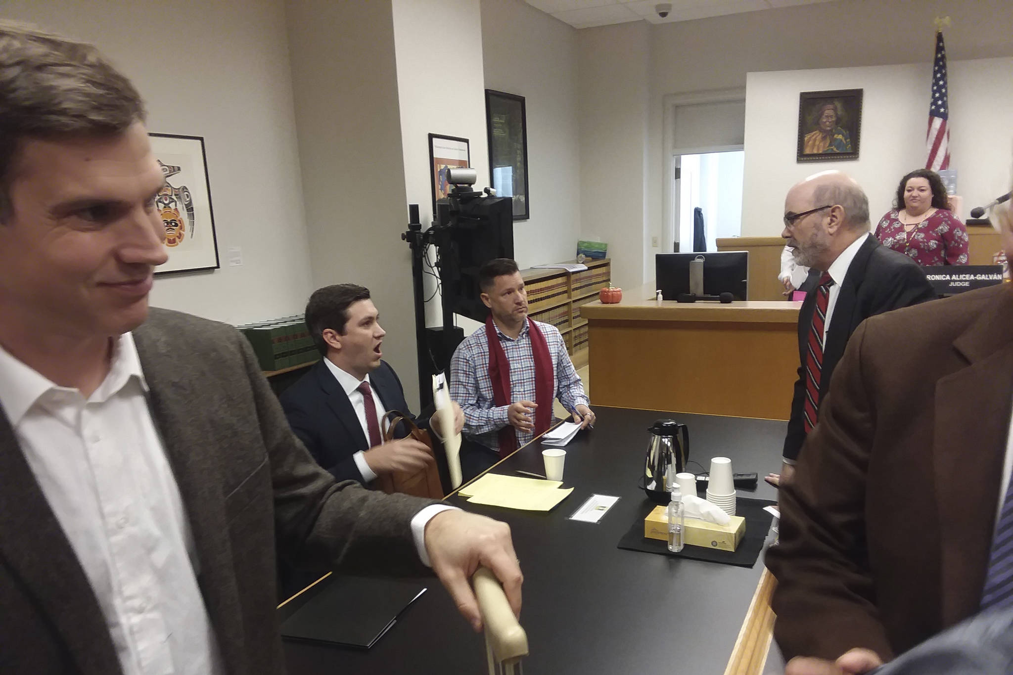 Judge Veronica Alicea-Galván’s courtroom just after hearing arguments on the I-27 lawsuit on Friday, Oct. 13, 2017. From left to right: Mark Cooke of the ACLU-WA; State Rep. Drew Stokesbary, serving as counsel to the defendants; Bothell City Council member and I-27 organizer Joshua Freed; Jeff Slayton, counsel from the Seattle City Attorney’s Office; court staff; and the brown-coated shoulder of Dr. Bob Wood, former director of the HIV/AIDS Program at Public Health Seattle/King County. Photo by Casey Jaywork