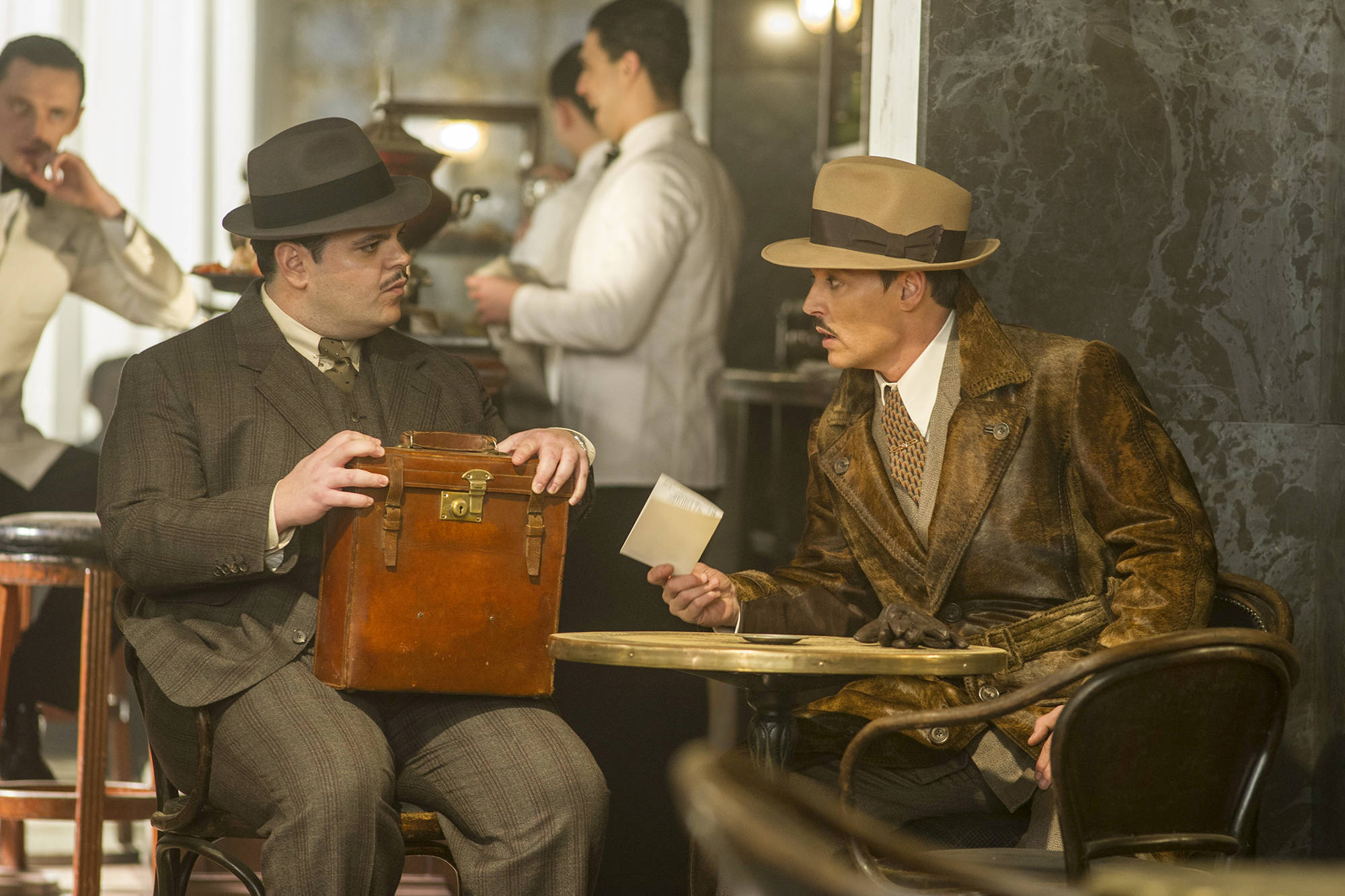 Photo by Nicola Dove/Twentieth Century Fox                                Josh Gad, left, and Johnny Depp star in Murder on the Orient Express.