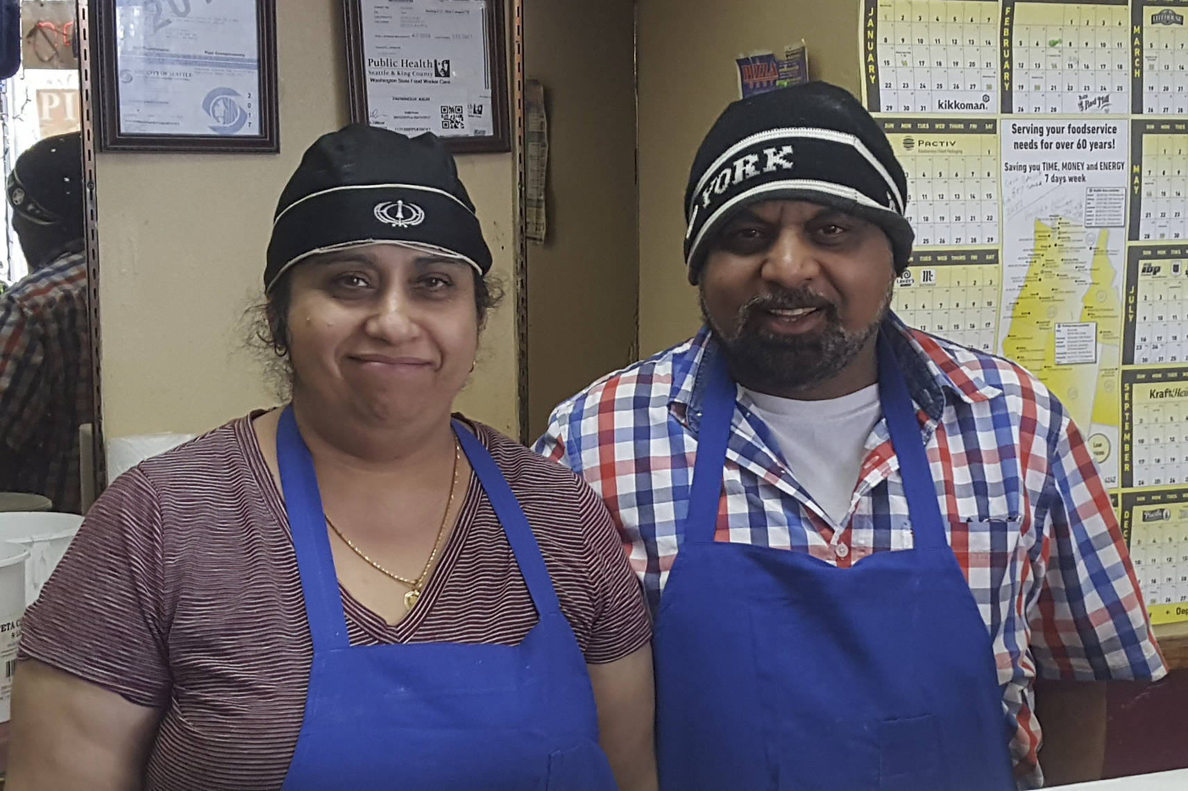 Jagajit Singh Samra and his wife Parwinder in their West Seattle business, A Pizza Mart. Courtesy of Keep Seattle Livable for All