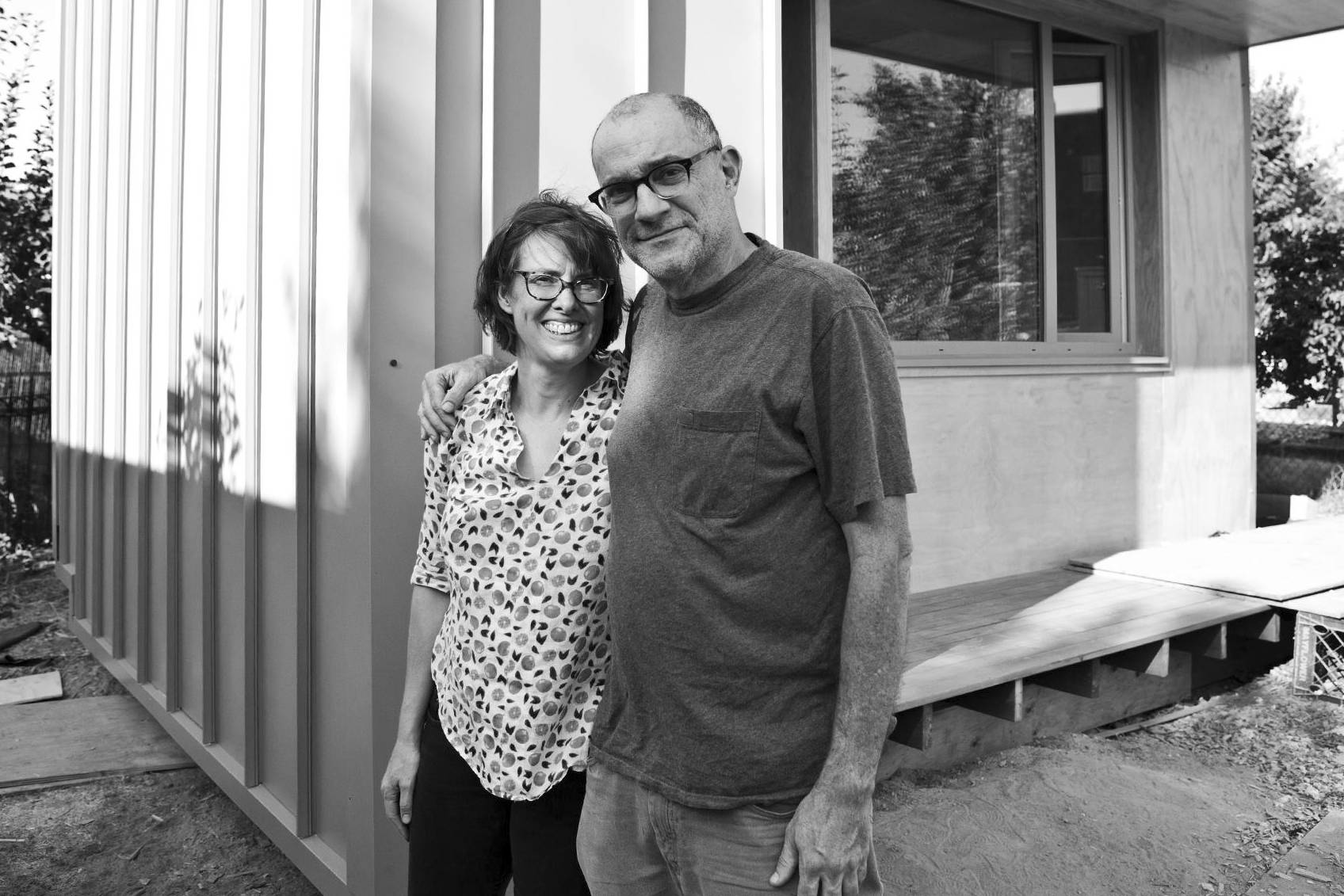 Hosts Kim Sherman and Dan Tenenbaum stand in front of the pilot BLOCK home in Beacon Hill. Photo courtesy Facing Homelessness