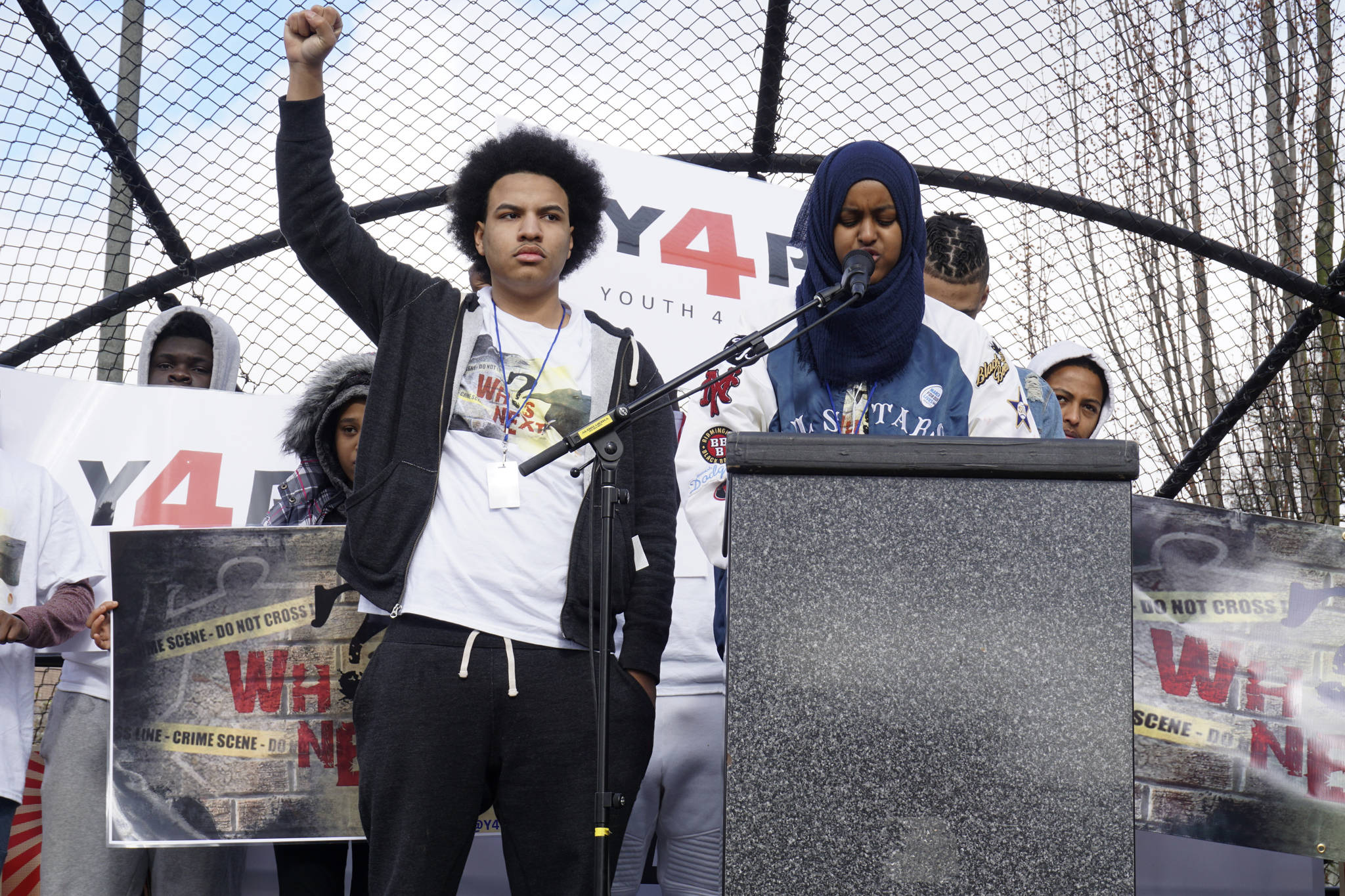 Elijah Lewis (left) from Youth 4 Peace shared the names of Seattleites who have died from gun violence. Photo by Melissa Hellmann