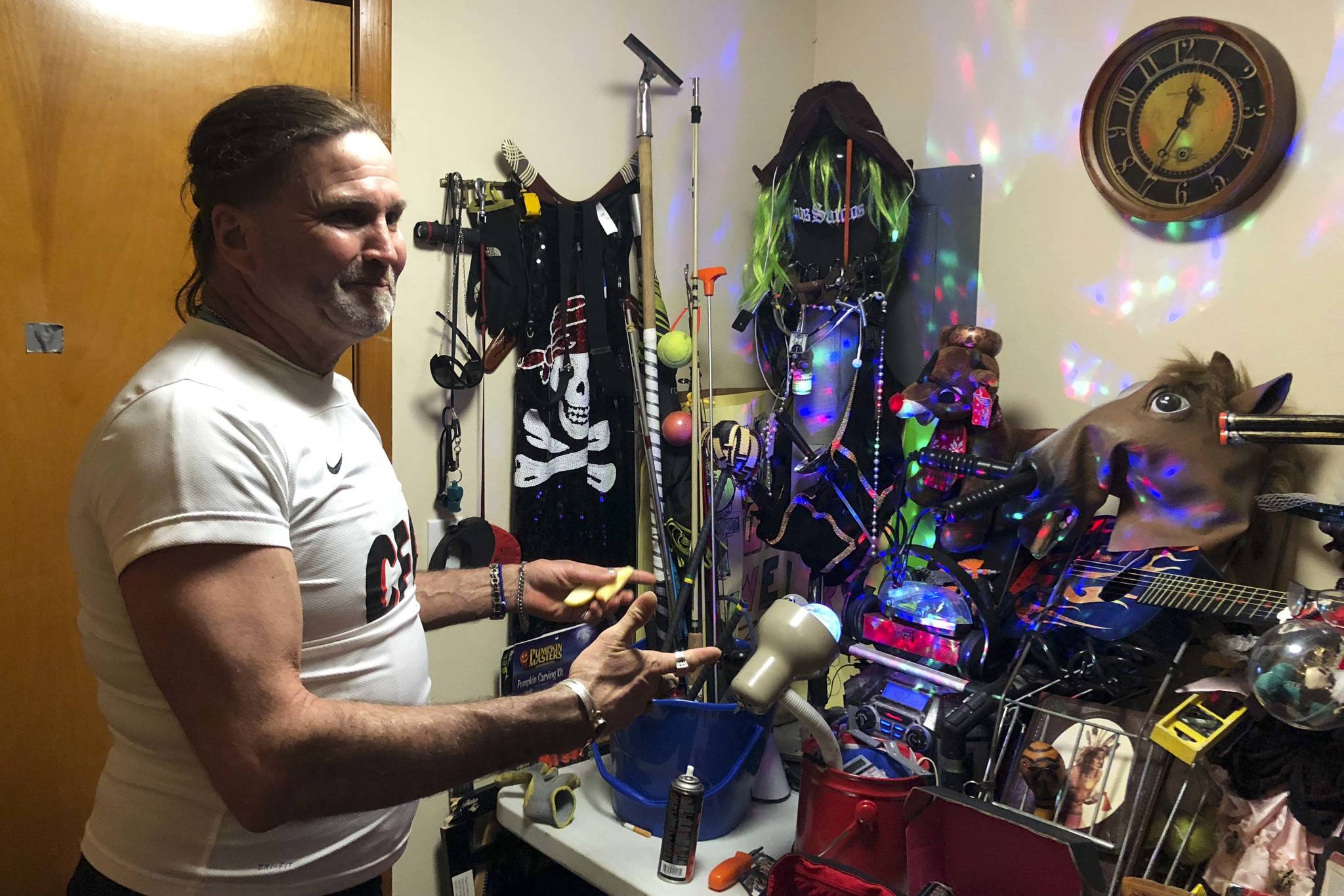 Kurt Niklas shows some of the belongings in his Cate Apartments unit operated by the Low Income Housing Institute. Photo by Melissa Hellmann