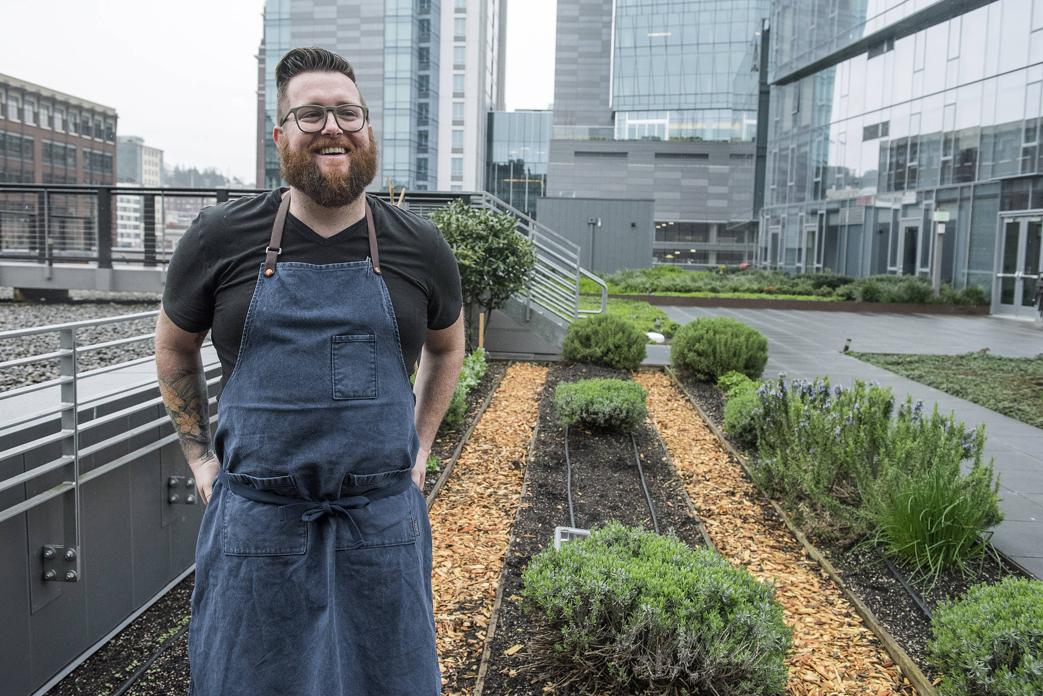 Chef Daniel Cox shows off the urban garden on top of Quality Athletics. Photo by Morgen Schuler