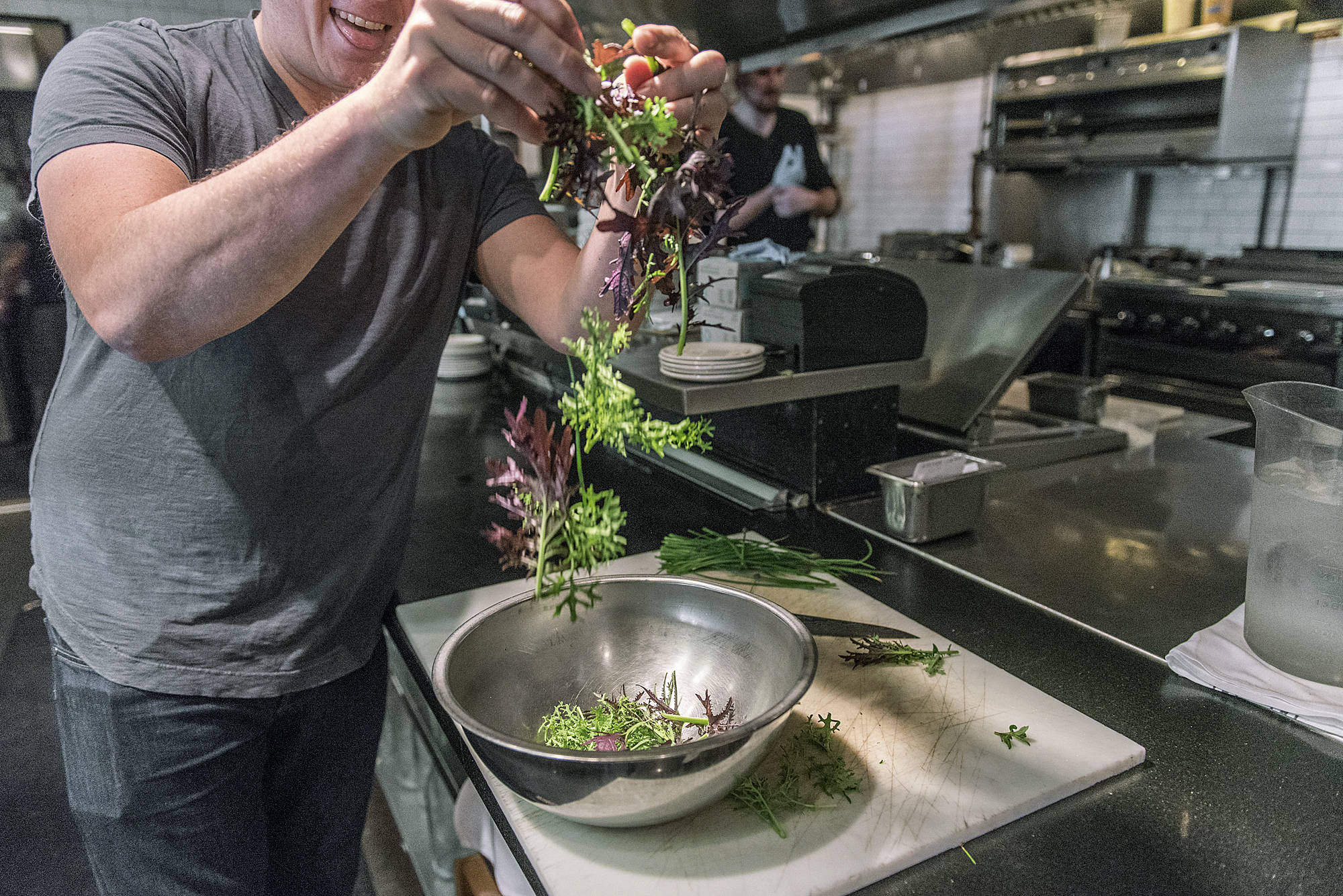 Bastille chef Jason Stoneburner employs ingredients from the restaurant’s rooftop garden in the kitchen. Photo by Morgen Schuler