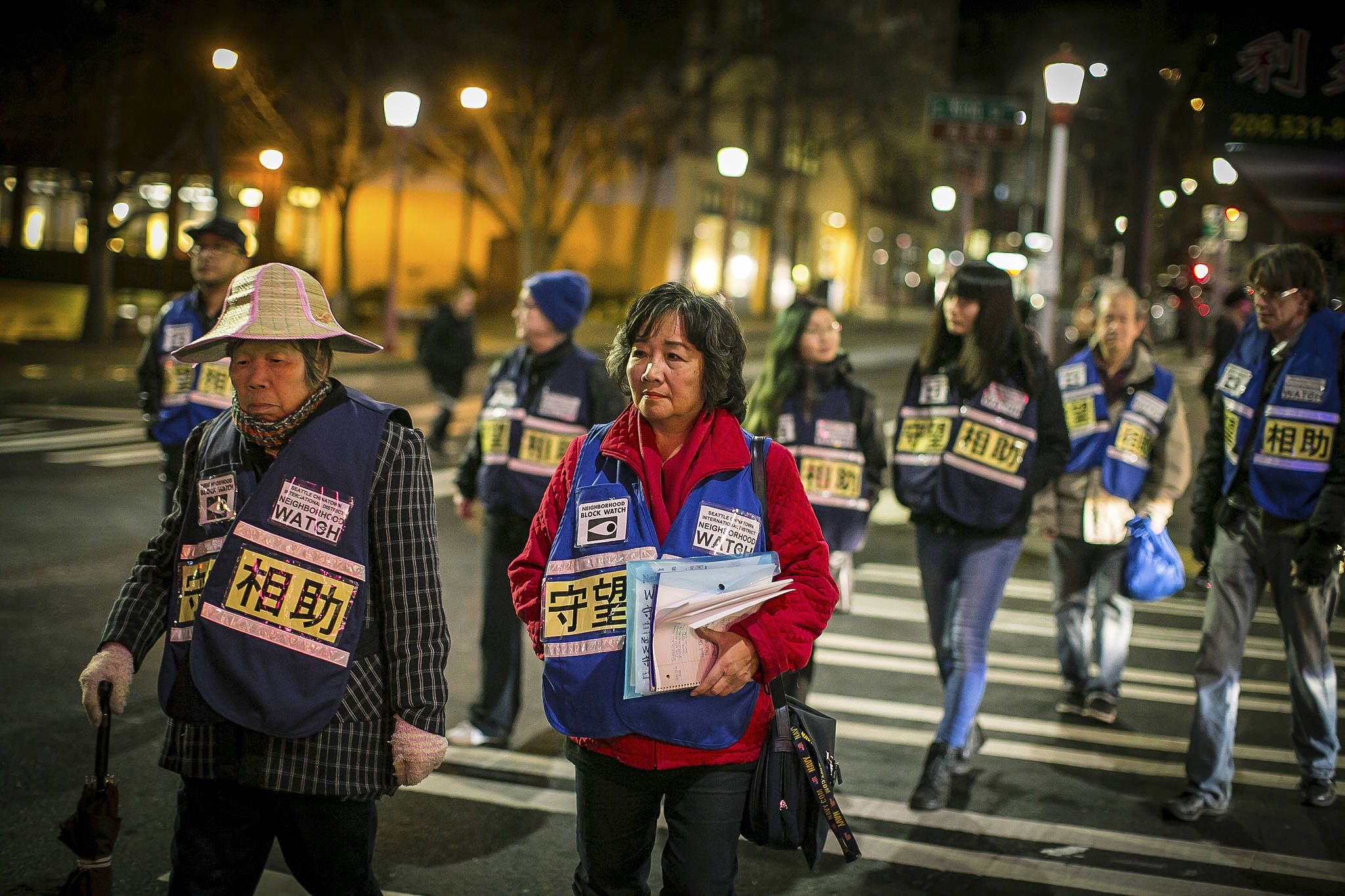 Susan Lee Woo (center) is one of the leaders of a private block watch in the Chinatown/International District. The block watch has been continuous since 2009. Photo by Paul Joseph Brown/InvestigateWest