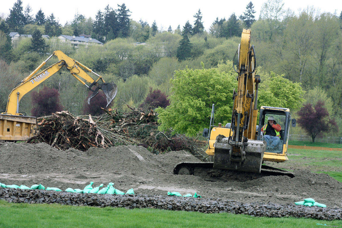 Crews clear the way for development at Riverbend’s former par 3 golf course in Kent. Photo by Mark Klaas