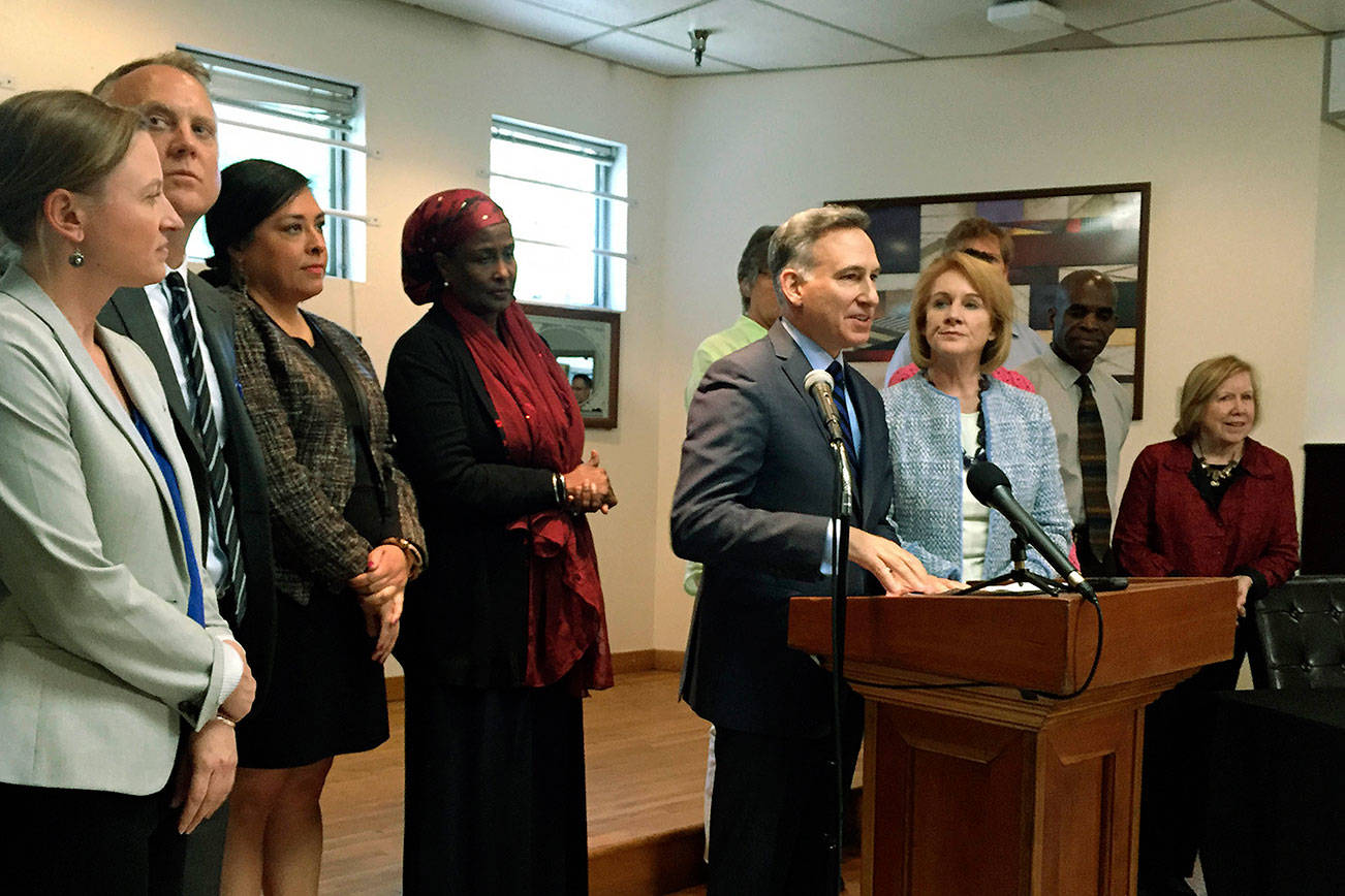 Board members of All Home stand behind King County Executive Dow Constantine and Seattle Mayor Jenny Durkan during a May 3 press conference at the Salvation Army William Booth Center. Photo by Josh Kelety