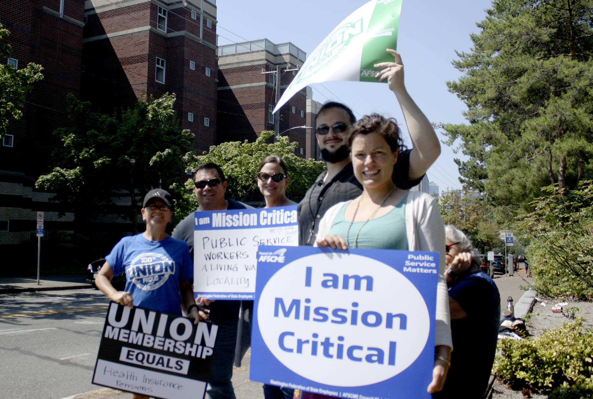 Developmental Disabilities Administration employees take a break during the workday to advocate for higher pay and affordable health insurance on August 9, 2018. Photo by Melissa Hellmann