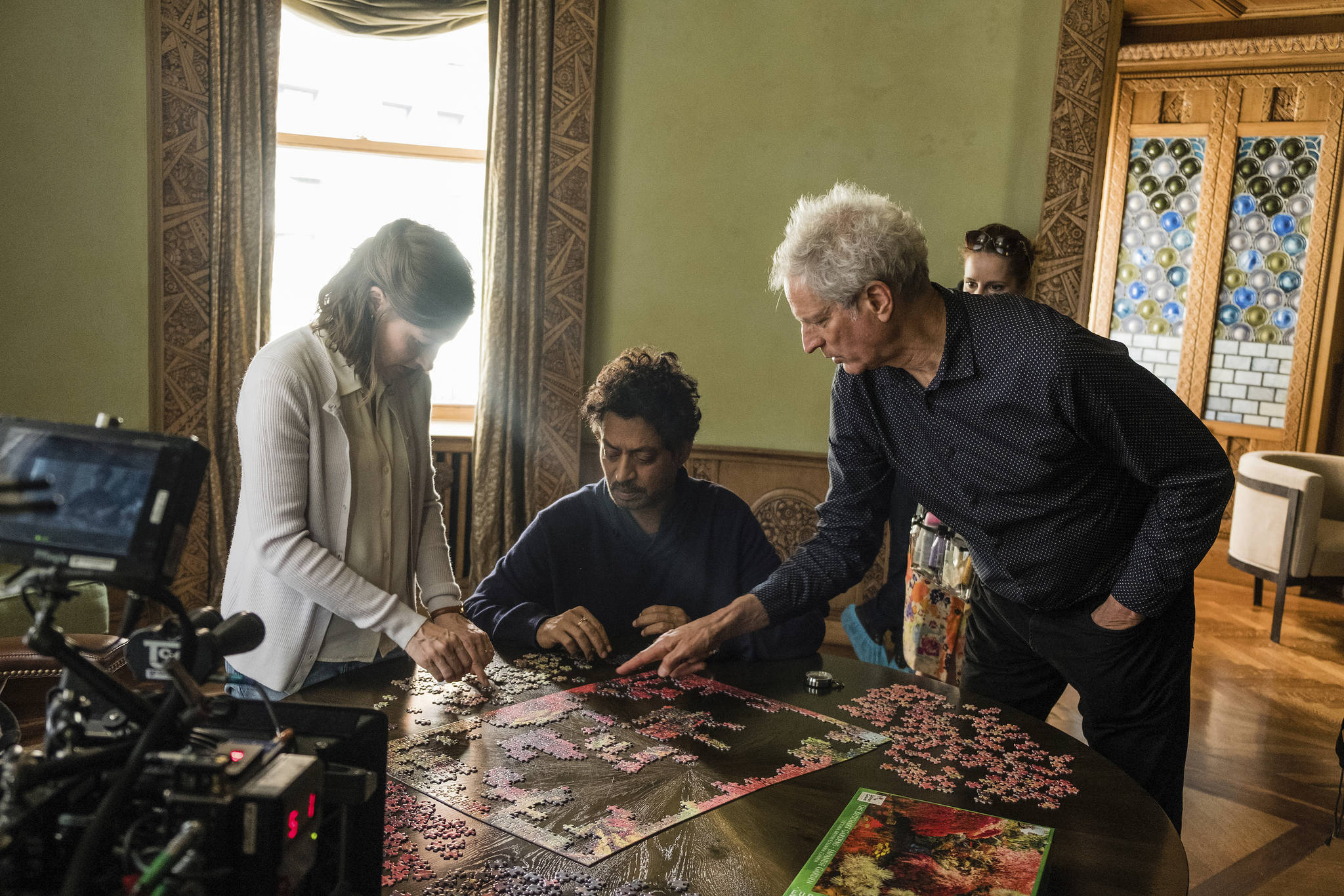 Kelly Macdonald, Irrfan Khan, and director Marc Turtletaub put together the pieces on the set of Puzzle. 
Photo by Linda Kallerus/Sony Pictures Classics