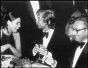 Evans laughing it up with Ali MacGraw and Henry Kissinger.