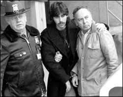Jesse (center) and Arnold Friedman under arrest.