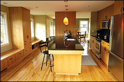 The kitchen was redone to feature a black granite-topped island, with seating for four.
