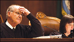 Gerry Alexander, chief justice of the Washington state Supreme Court, listens Monday in Olympia to arguments in the case of the gubernatorial recount.