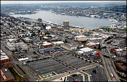 A 12-acre parking lot, foreground, will become the campus of the Bill and Melinda Gates Foundation. The Seattle Center grounds are not quite visible at lower left. This view is looking northeast from the Space Needle, with Lake Union in the background.