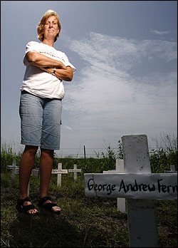 Near Crawford, Texas, Cindy Sheehan stands among crosses symbolizing soldiers who died in Iraq.