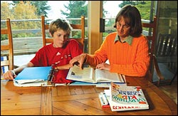 Susan and Nathan Conners of Normandy Park working on science and social studies at home—because they get short shrift at school. In the world of WASL, the three R's rule the classroom.