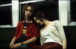 Haruhiko Kato (left) and Koyuki on a train to the afterworld.