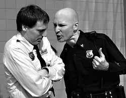 Cop vs. rent-a-cop:Bill (Roy Stanton, right) confronts Jeff (Evan Whitfield).