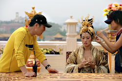 Zhang (left) with Gong Li on set.