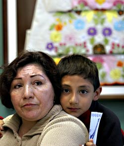 Maria Vargas and her son, Cesar, attend a STOP (Section 8 Tenants Organizing Project) meeting at Catholic Community Services in the Central District.