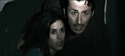 Olivia Bonamy and Michaël Cohen cower in the dark.