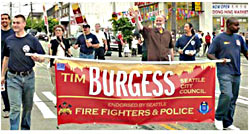 Seattle firefighters plan to do a lot more than just march for Tim Burgess (pictured, waving).