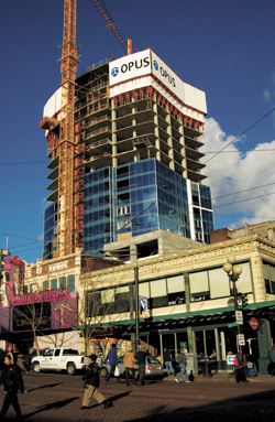 Fifteen Twenty-One rises behind a strip club and a two-story, Samis-owned, corner building.