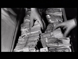 The robbers' real hands count money that was worthless in the West.