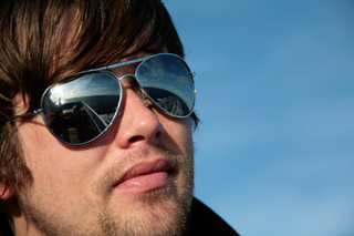 Young man with sunglasses on a ferry from Denmark to Norway