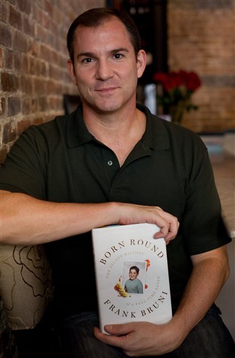 Frank Bruni, former New York Times food critic, holds a copy of his book "Born Round" in New York, Friday, Aug. 14, 2009. (AP Photo/Yanina Manolova)