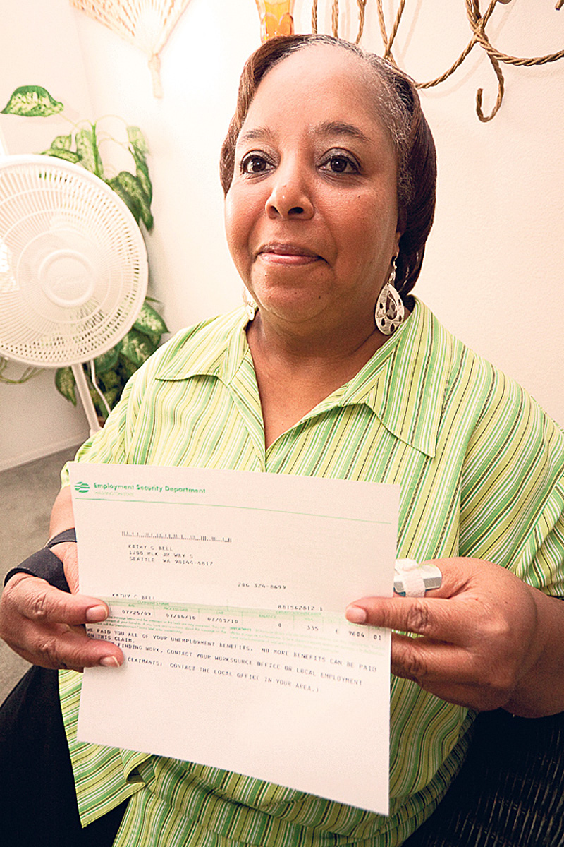 Kathy Bell holds the letter announcing that her unemployment benefits are about to expire.