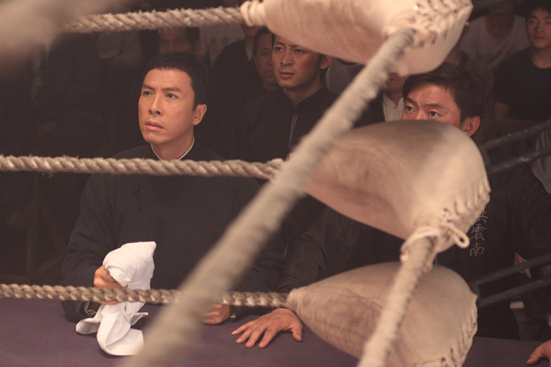 Donnie Yen (left) watches the action.